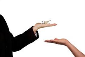 photo: woman holding keys to house