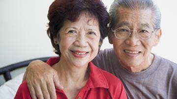 Close-up of smiling senior Asian couple