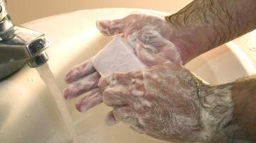 Wahinging hands with soap in sink
