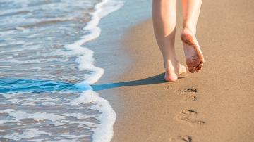 person walking on sand