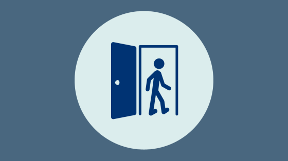 A man walking through a door