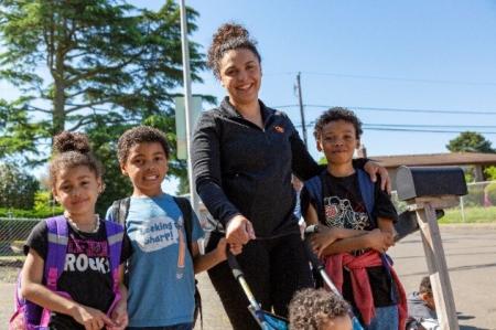 Adult and 3 children before school