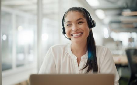 woman with phone headset smiling