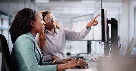 two women working together at a computer
